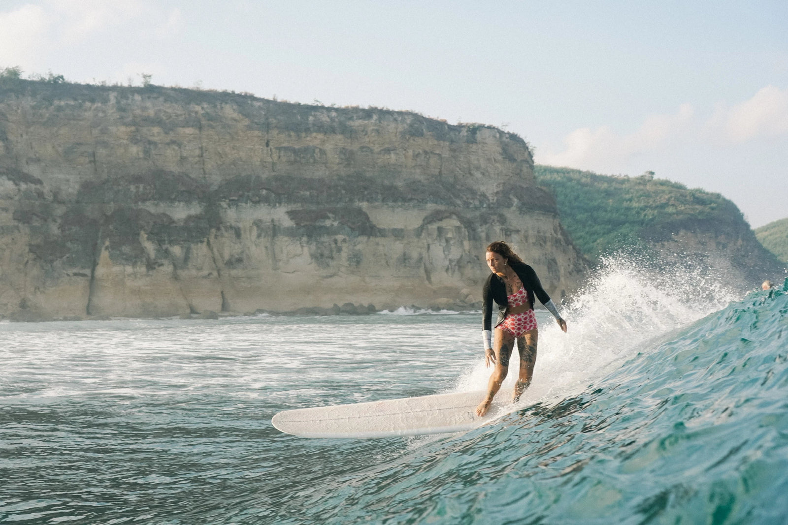 Kassia Meador surfing at sunset